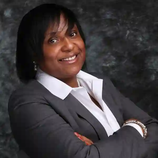 A woman in a gray suit and white shirt