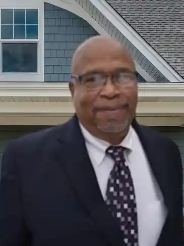 A man in a suit and tie standing outside.