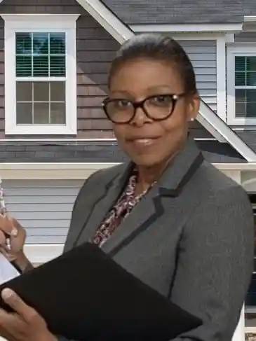 A woman in glasses holding papers and a cell phone.