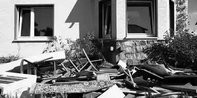 A pile of debris in front of a house.