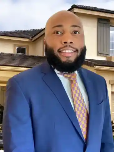 A man in a suit and tie standing outside of a house.