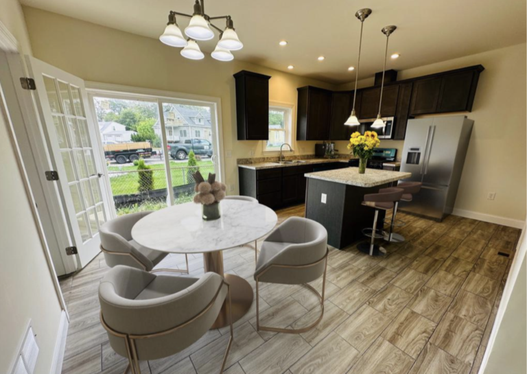 A kitchen with a table and chairs in it