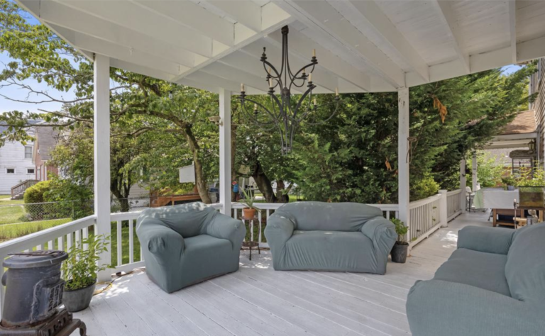 A porch with two couches and a chandelier.