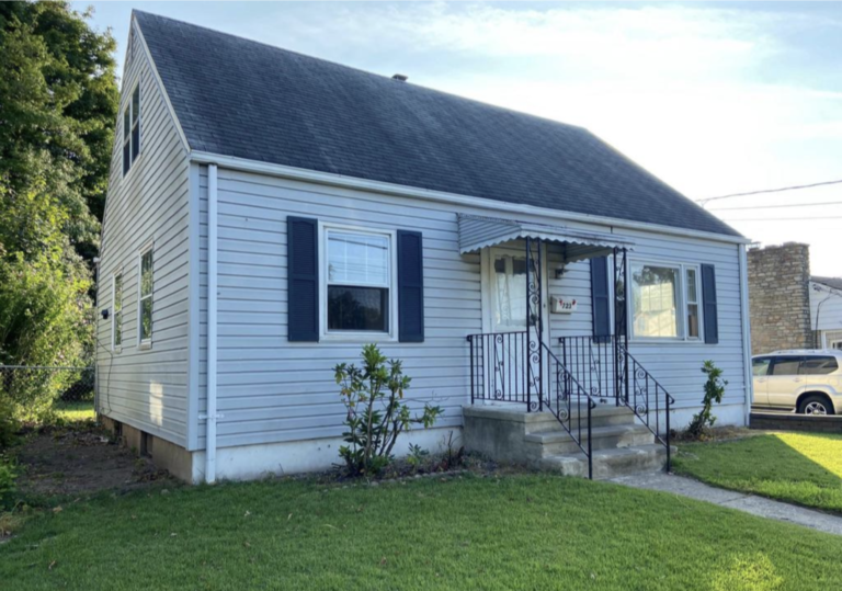 A house with a black roof and white trim.