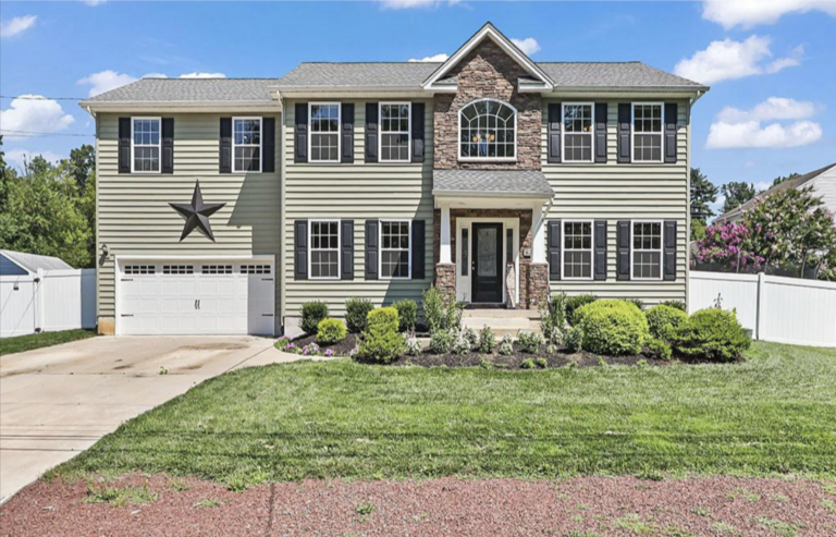 A large house with a yard and garage.